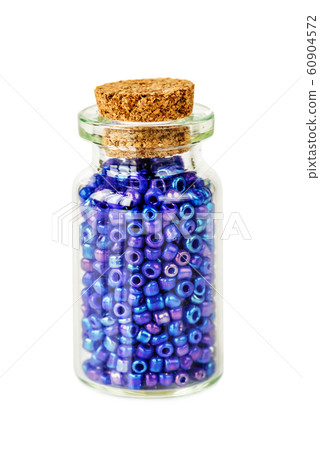 Blue beads in small glass jar Blue beads in small glass jar 60904572