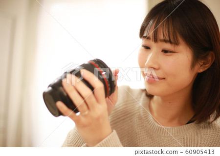 Woman taking care of the lens Woman taking care of the lens 60905413