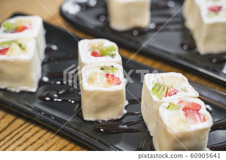Dessert rolls minari from strawberry, kiwi, banana and cream cheese wrapped in thin rice pastry is real dianty. Various fruits and berries inside, pancake outside and served with strawberries sauce. A 60905641
