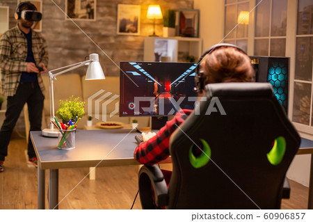 Professional video gamer female playing an online shooter game Professional video gamer female playing an online shooter game 60906857