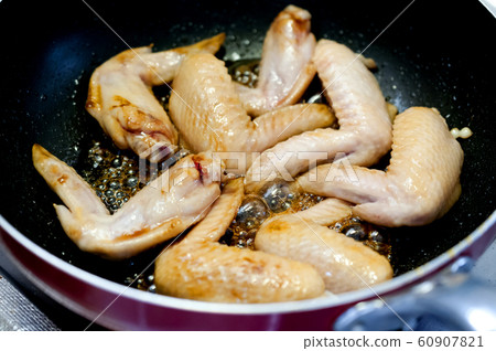 Chicken wings with sweet teriyaki (during cooking) 60907821