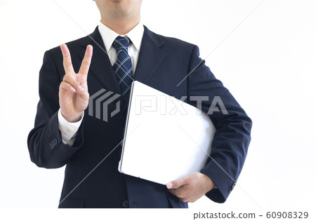 A man in a suit holding a laptop A man in a suit holding a laptop 60908329