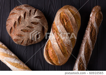 Top view photo of fresh baked bread on painted black wooden table 60910565