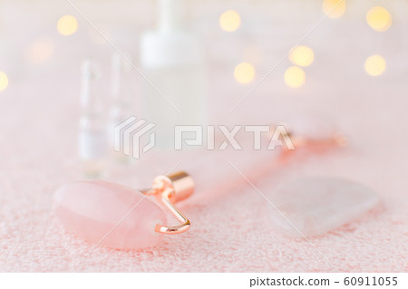 real rose quartz facial roller, gua sha massage stone and face serum, soft focus 60911055