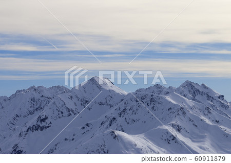 Snowy slope in high winter mountains and sunlit Snowy slope in high winter mountains and sunlit 60911879