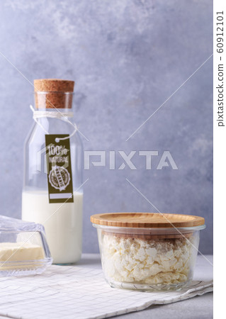 dairy products concept on grey bottle of milk with label natural products cottage cheese and butter 60912101