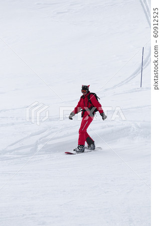 Snowboarder on snowy ski slope Snowboarder on snowy ski slope 60912525
