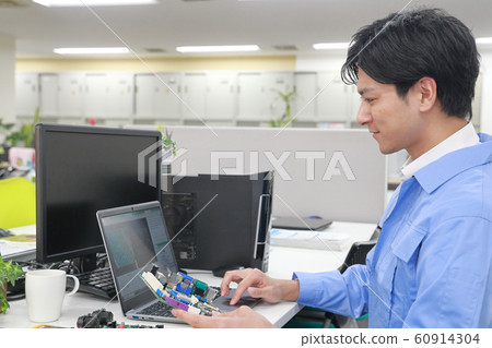 Engineer 1 holding a board and designing 60914304