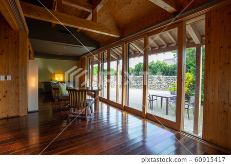 Spacious living room with glass doors, wooden structure and wooden flooring 60915417