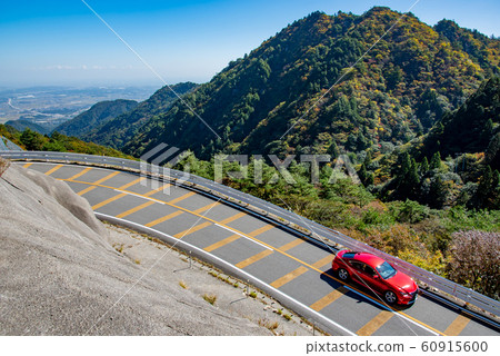 A red car passing through the Suzuka Skyline in Mie Prefecture 60915600