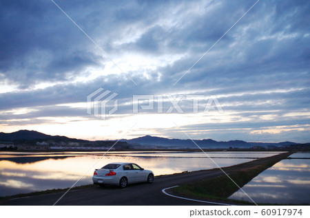 Rural scenery with sky clouds and clear sky reflected on the water surface 60917974