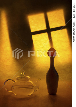 Still life with a teapot and a vase on a window 60918366