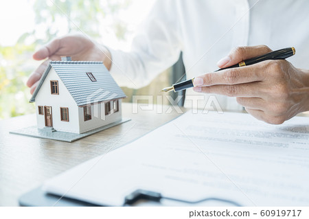 House model with agent asking costumer for contract to buy, get insurance or loan real estate. 60919717