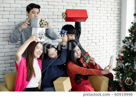 Selfie of group young Asian with gifts at home in 60919996