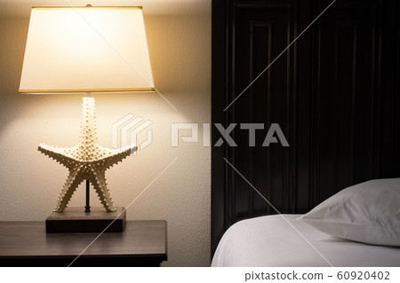 comfortable hotel room. Lamp on the table near bed comfortable hotel room. Lamp on the table near bed 60920402
