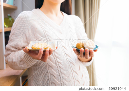 Pregnant woman with Japanese sweets and Western sweets Bun and cookies 60921044