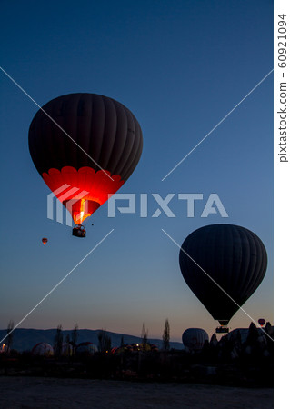 Hot air balloon flying over spectacular Cappadocia 60921094