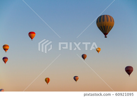 Hot air balloon flying over spectacular Cappadocia 60921095