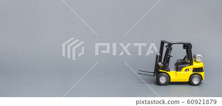 Yellow forklift truck side view on gray background. Warehouse equipment, vehicle. Unloading, transportation, loading cargo. Logistics and transport, industry and agriculture. Banner, copy space Yellow forklift truck side view on gray background. Warehouse equipment, vehicle. Unloading, transportation, loading cargo. Logistics and transport, industry and agriculture. Banner, copy space 60921879