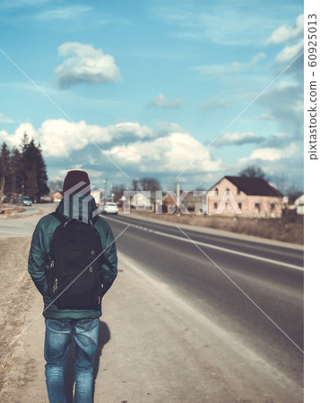 Man in a cap with a backpack Man in a cap with a backpack 60925013
