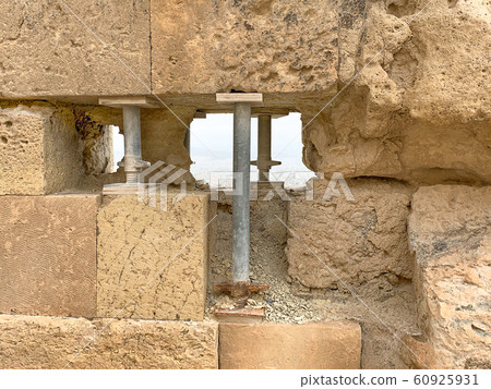 Temporary steel pillars support an ancient stone wall Temporary steel pillars support an ancient stone wall 60925931