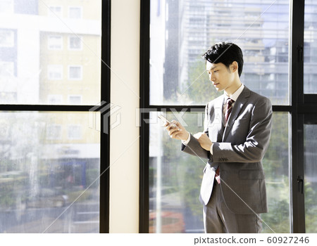 Businessman Smartphone Check 60927246
