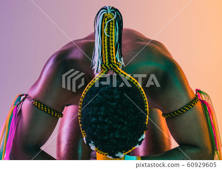 Muay thai. Young man exercising thai boxing on gradient background 60929605