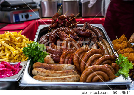 Assortment hot grilled sausages and fried potatoes 60929615