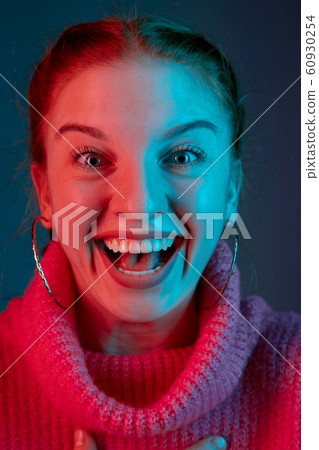 Caucasian woman's portrait isolated on gradient studio background in neon light 60930254