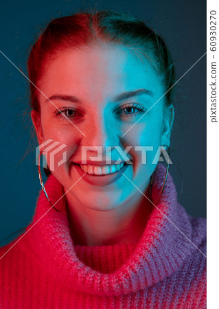 Caucasian woman's portrait isolated on gradient studio background in neon light 60930270