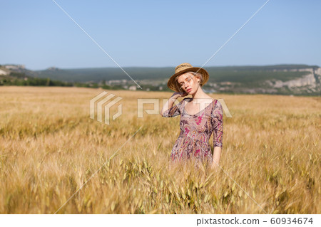 portrait of a beautiful fashionable blonde woman in a hat in a field of ripe wheat portrait of a beautiful fashionable blonde woman in a hat in a field of ripe wheat 60934674