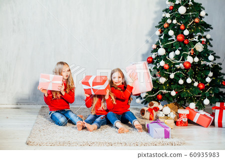 three girls blonde sisters girlfriends gift new year tree holiday Christmas three girls blonde sisters girlfriends gift new year tree holiday Christmas 60935983