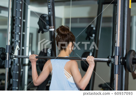 Young woman, muscle training, gym Young woman, muscle training, gym 60937093