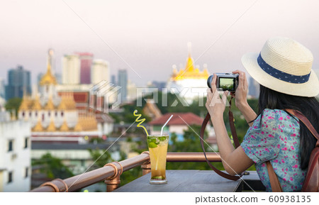 Asian girl relax on the roof top bar in Bangkok Asian girl relax on the roof top bar in Bangkok 60938135
