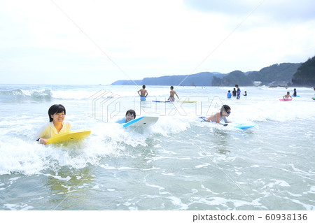 Family enjoying a sea bath Family enjoying a sea bath 60938136