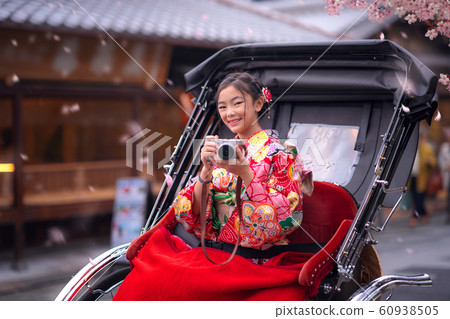 Japanese girl take a photo by her camera and sit 60938505