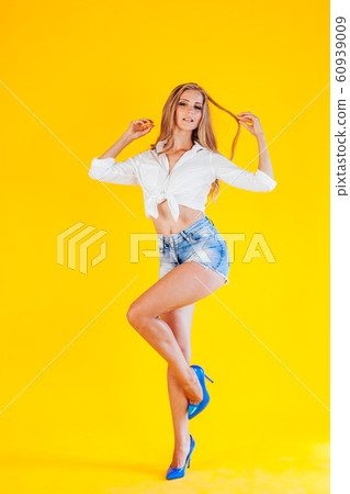 beautiful young girl, blonde on yellow background 60939009