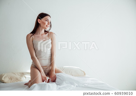 girl in lingerie woke up in the morning in the bedroom 60939010