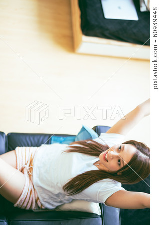 Young woman relaxing on the couch 60939448