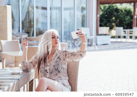 a girl takes pictures of yourself on your phone 60939547