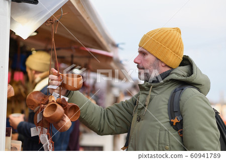 Man selecting gifts on the Christmas market in 60941789