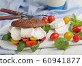 Sandwich with rye bread, goat cheese, tomatoes, 60941877