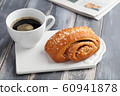 Cinnamon roll and a cup of coffee 60941878