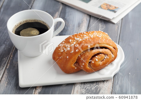 Cinnamon roll and a cup of coffee Cinnamon roll and a cup of coffee 60941878