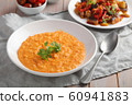 Pumpkin soup decorated with basil in a vegetarian 60941883