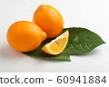 Orange colored lemons on a cutting board 60941884