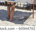 teenager removes wet swimming trunks in the locker room 60944702