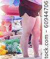 Woman legs with red sunburn skin on the beach 60944706