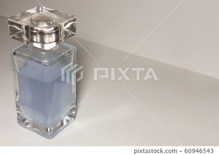 Transparent glass bottle with sky blue liquid on 60946543