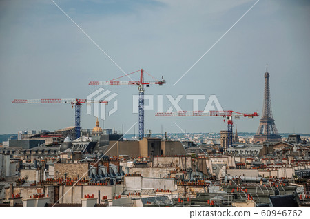 Buildings rooftops with cranes and Eiffel Tower in Paris Buildings rooftops with cranes and Eiffel Tower in Paris 60946762